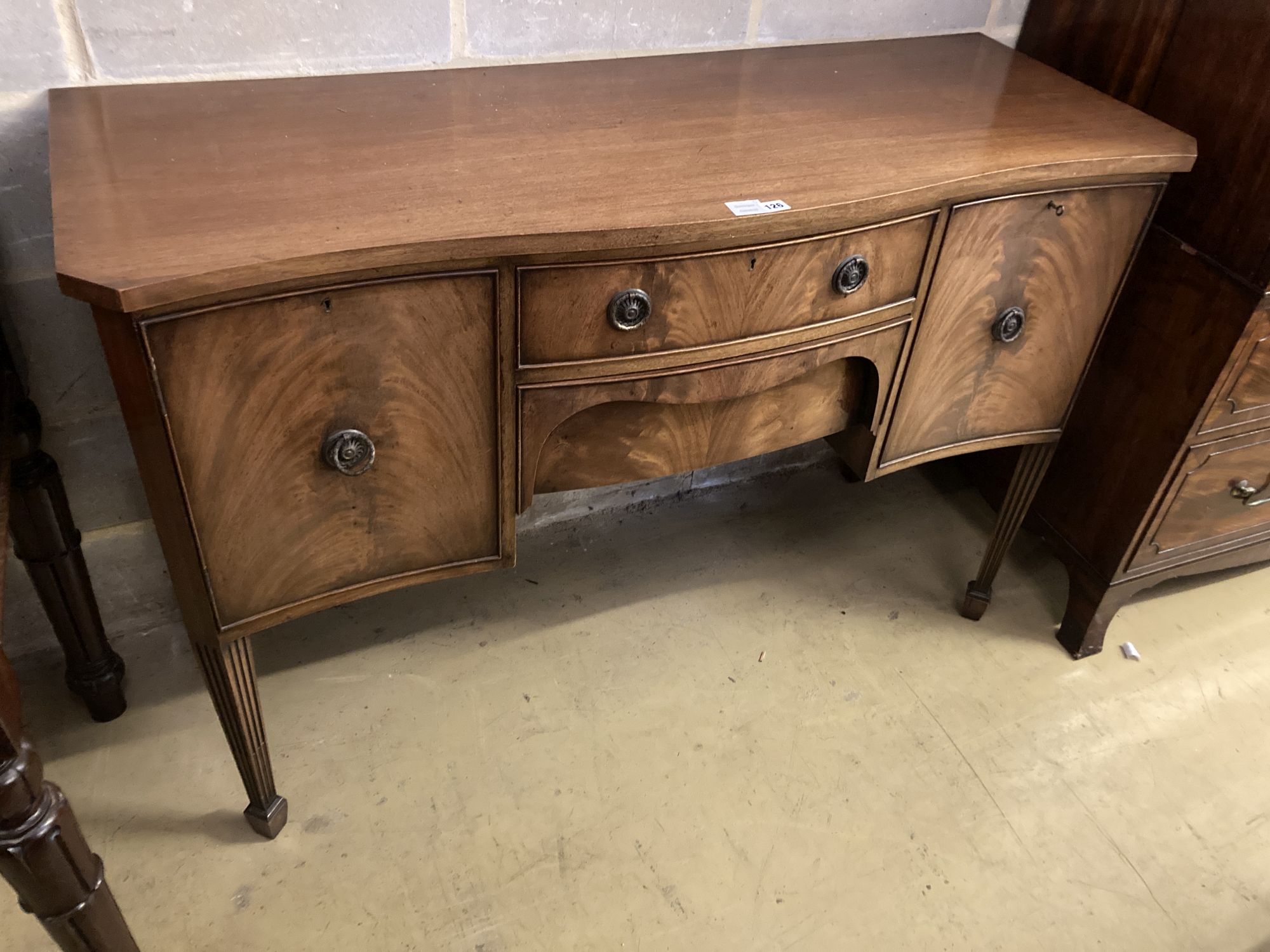 A George III style mahogany serpentine fronted sideboard, length 138cm, depth 52cm, height 92cm